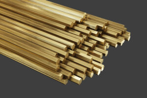Brass metal, rods of brass. Rolled metal products. Isolated on gray background, clipping path included. 3d illustration.